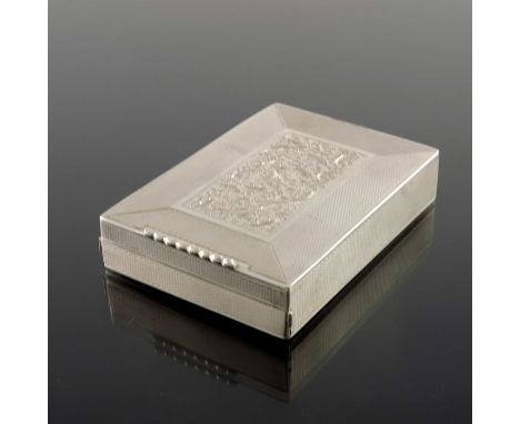 A Continental white metal combination compact, circa 1950s, engine turned, with central chased foliate scroll panel, pull out