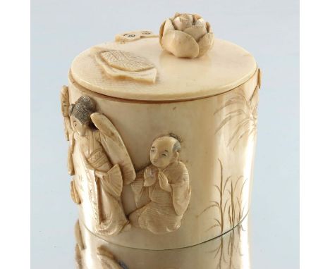 A 19th century Japanese ivory box and cover, Meiji, cylindrical form, carved in relief with figures in a landscape, the lid w