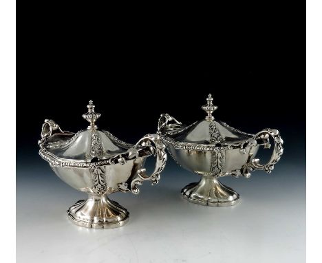 A pair of Victorian silver sauce tureens, Robert Garrard, London 1852, each of twin handled lobed pedestal boat form, bead an