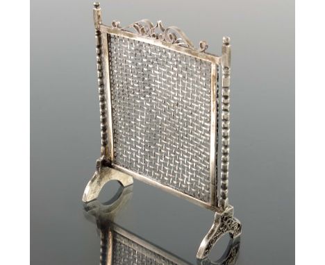 A novelty silver fire screen, decorated with filigree and bobbin turned supports and a central mesh, 7cm high, 0.52ozt