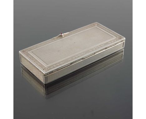 A French silver snuff box, circa 1890, rectangular section, engine turned and chased with floral garland border and a ruby ca