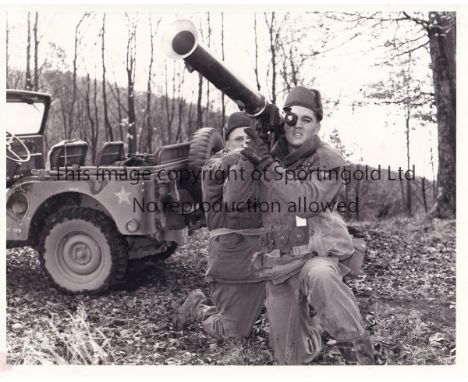 ELVIS PRESLEY     Black &amp; white 10" X 8" Press photograph showing Presley being trained with a rocket launcher in army ki