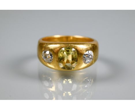 A 22ct yellow gold gypsy ring set with two diamonds and central yellow stone, possibly sapphire, diamond weight approx 0.50 c