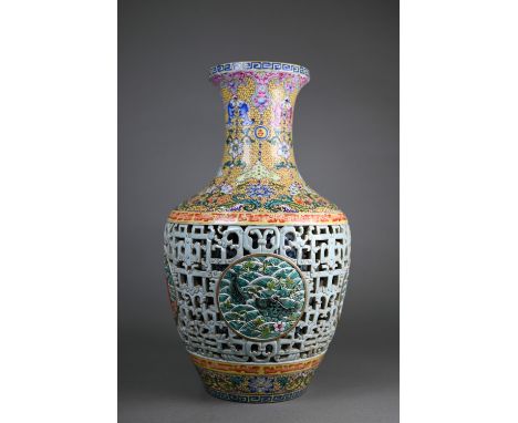 A Chinese yangcai double walled vase, the lotus scroll blue and white cylindrical inner vase partially revealed by a pale gre