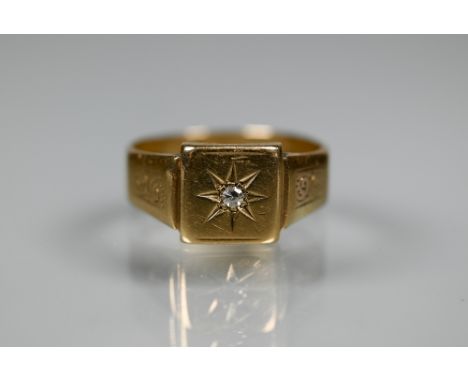 A 9ct yellow gold signet ring with starburst set diamond, size S, approx 4.4g 