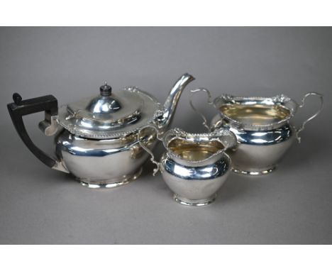 A late Victorian silver three-piece bachelor tea service&nbsp; with gadrooned and floral-chased rims and composite mounts, Ch