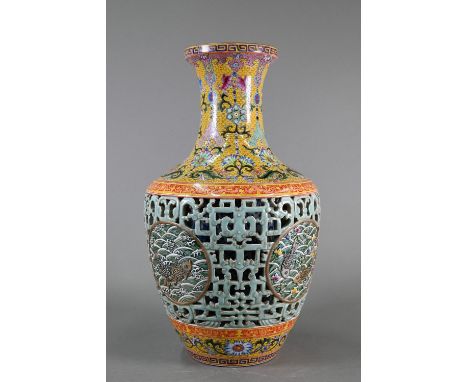 A Chinese yangcai double walled vase, the lotus scroll blue and white cylindrical inner vase partially revealed by a pale gre