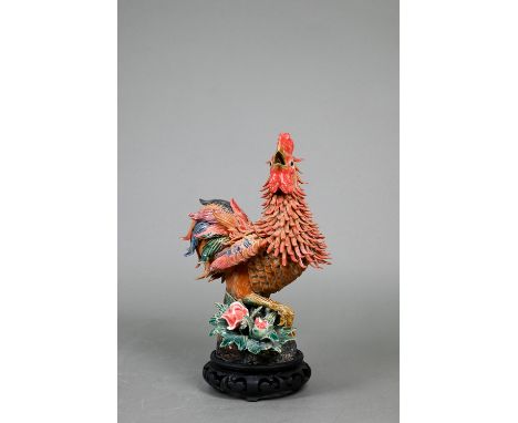A late 19th or early 20th century Chinese (possibly Shiwan) polychrome pottery rooster standing on naturalistic base, impress