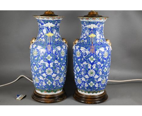 A pair of 19th century Chinese blue ground baluster vases painted with continuous composite floral scroll and longevity shou 