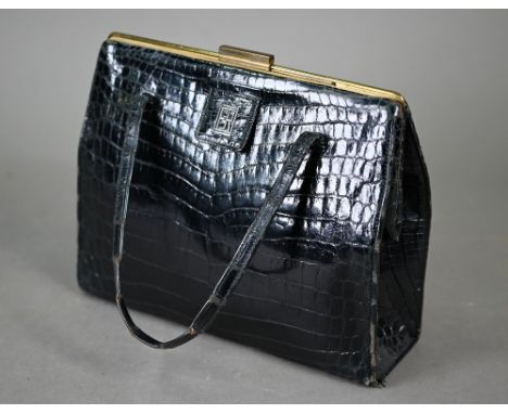 Asprey - A vintage black crocodile handbag, circa early 1960s, with twin handles, gold tone hardware with sliding opener, ful