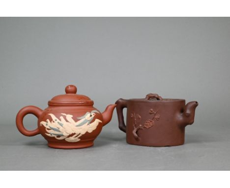 A late 19th or early 20th century Chinese Yixing 'tree-trunk' teapot, the flat cover and body with moulded prunus decoration,