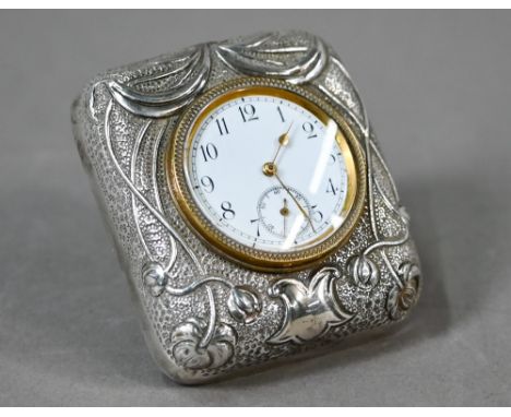 An Edwardian travel clock with Art Nouveau embossed and chased silver front to the strut-case, Douglas Clock Co, Birmingham 1