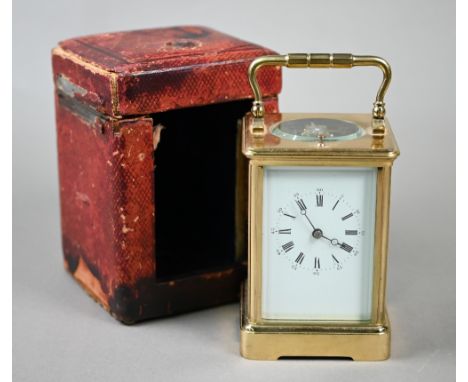 A gilt-cased two train 8-day carriage alarm clock with white enamelled and Roman numeral dial, 13.5 cm high and c/w battered 