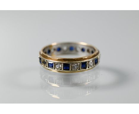 A 9ct yellow and white gold eternity ring set alternate blue sapphires and white stones, size O, approx 3.2g all in 