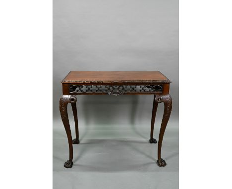 A Regency mahogany small serving table of Irish Chippendale style, the rectangular top with moulded edge over a pierced and m
