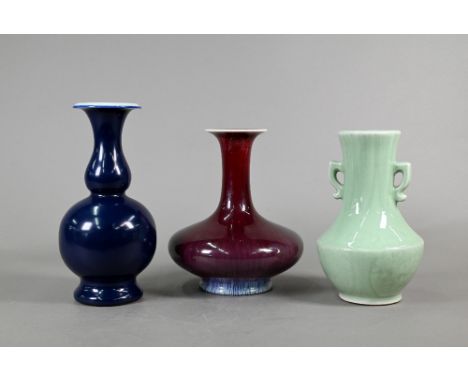 Three 20th century Chinese monochrome vases; a copper red yao-bian flambe glazed bottle vase, 23 cm high; a royal blue double