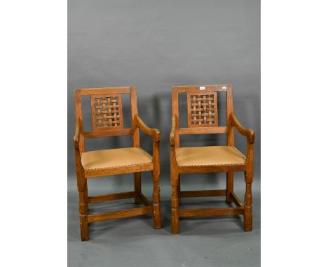 The workshop of Robert Thompson (Kilburn) a companion pair of 'Mouseman' oak carver chairs with lattice splats over swept arm