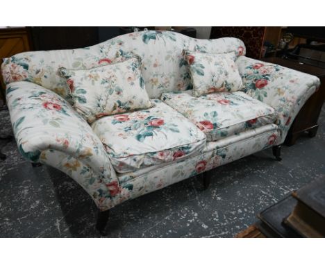 A Georgian style hump back scroll arm sofa, in floral Colefax &amp; Fowler fabric, raised on three front legs on castors, 222