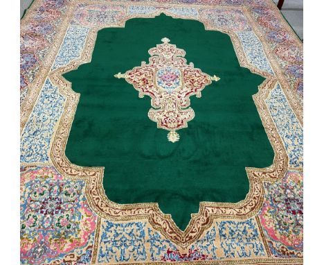 Large multi ground wool carpet with green central panel 4.0m by 3.04m