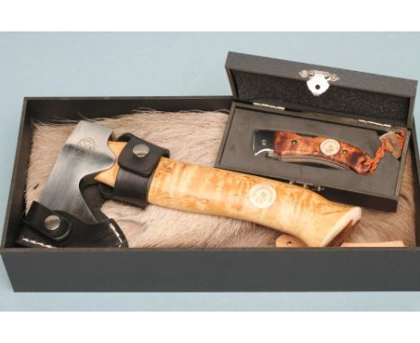 A SWEDISH KARESUANDO AXE, the curly birch handle tipped with reindeer antler, stainless steel blade, leather blade guard and 