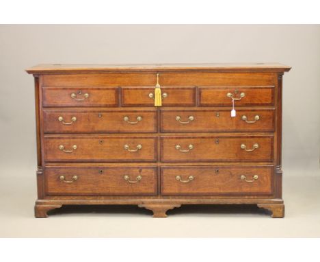 A GEORGIAN OAK AND MAHOGANY BANDED LANCASHIRE DRESSER, 18th century, the moulded edged hinged lid opening to a baize lined in