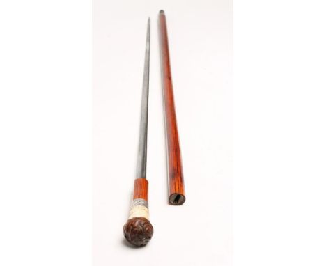 A MALACCA SWORD STICK, with 29 1/2" double edged blade, silver plated ferrule, carved bone section depicting a stag and an oa