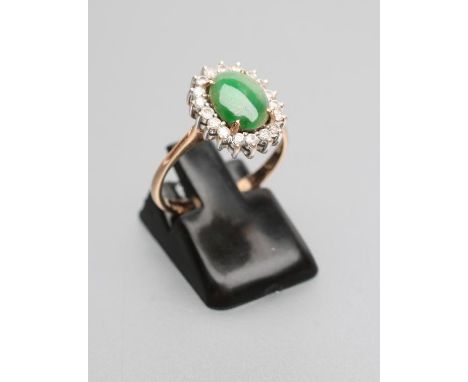 A JADE AND DIAMOND OVAL CLUSTER RING, the cabochon polished jade claw set to a border of numerous small stones to a plain sha