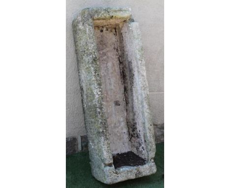 A LARGE GRANITE TROUGH of rough hewn narrow oblong form with mildly tapering sides, 19" x 53" x 13" (Illustrated) (Est. plus 