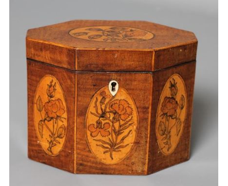 A GEORGIAN MAHOGANY TEA CADDY, late 18th century, of canted form with marquetry floral paterae, hinged lid opening to inner l