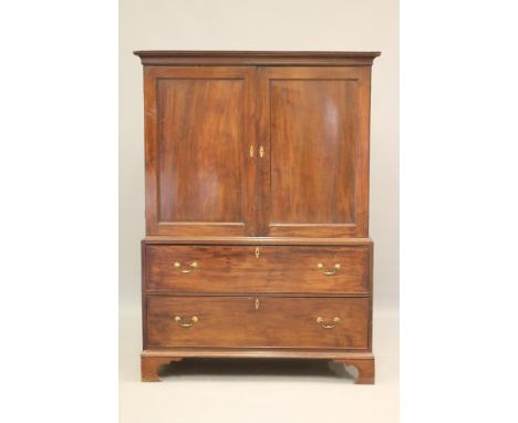 A GEORGIAN MAHOGANY LINEN PRESS, the cavetto moulded cornice over a pair of panelled doors enclosing three shelves and a shel