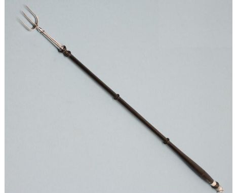 A LATE GEORGE III SILVER TOASTING FORK, maker Phipps &amp; Robinson, London 1811, the triple tine fixed to a baluster and rin