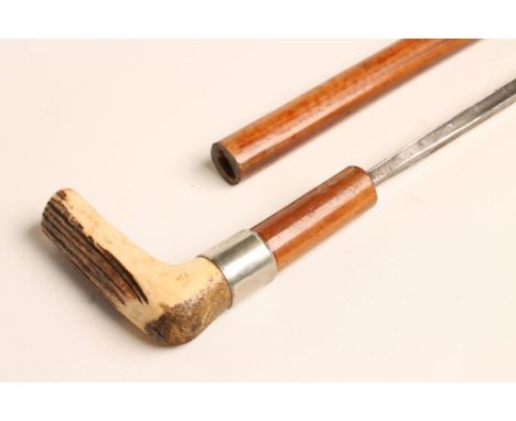 A MALACCA SWORD STICK, with 17 3/4" triangular section blade bearing remnants of etched decoration, white metal ferrule and s