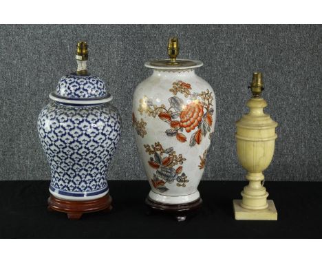 Three 20th century table lamps, including a Chinese blue and white lidded urn lamp, a carved alabaster lamp and a Japanese ha