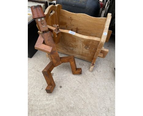 A WOODEN PLANT TROUGH AND A WOODEN GARDEN FIGURE 