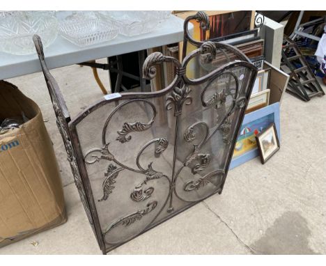 A DECORATIVE WROUGHT IRON FIRE SCREEN 
