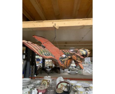 AN ORIENTAL STYLE HANDPAINTED WOODEN MODEL OF A FLYING BIRD LIKE FIGURE 