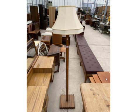 A MID 20TH CENTURY OAK STANDARD LAMP ON SQUARE SLATTED BLOCK BASE COMPLETE WITH SHADE 