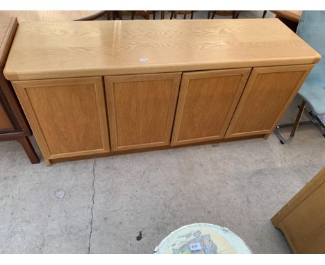 A DANISH MADE LIGHT OAK SIDEBOARD ENCLOSING FOUR CUPBOARDS, 66" WIDE 