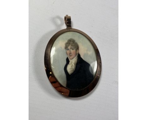A 19TH CENTURY OVAL PORTRAIT MINIATURE OF A GENTLEMAN IN BELIEVED GOLD FRAME 