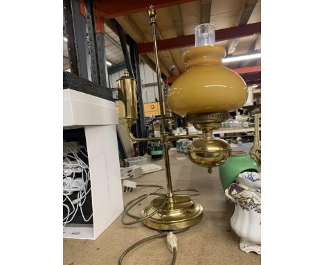 A HEAVY BRASS VINTAGE STYLE LAMP WITH MUSTARD GLASS SHADE AND CLEAR CHIMNEY HEIGHT APPROX 56CM 