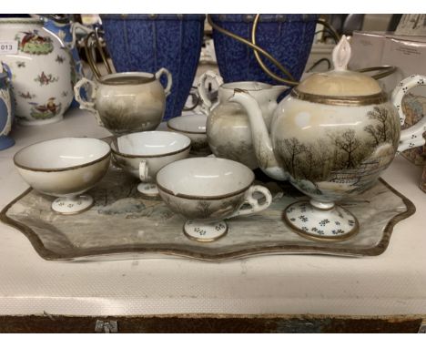 AN ORIENTAL TEASET TO INCLUDE A TRAY, TEAPOT, CREAM JUG, SUGAR BOWL, CUPS AND SAUCERS - SOME PIECES A/F 