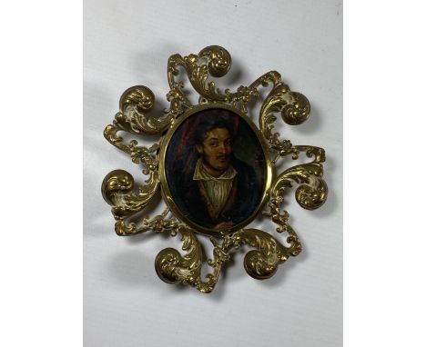 AN ORNATE BRASS FRAMED BYRONESQUE OIL PORTRAIT MINIATURE, LENGTH 14CM 