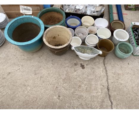 A LARGE ASSORTMENT OF GLAZED AND CERAMIC PLANTERS AND POTS 