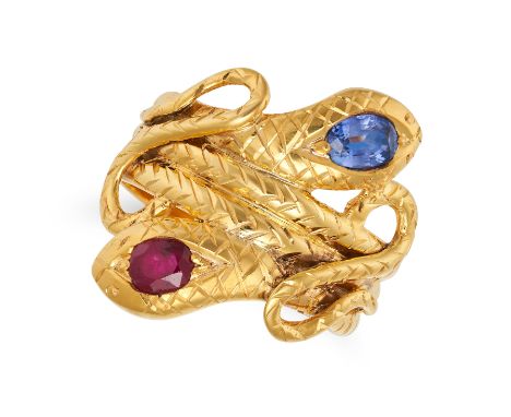 A RUBY AND SAPPHIRE SNAKE RING in 14ct yellow gold, designed as two coiled snakes, one head set with an oval cut sapphire, th