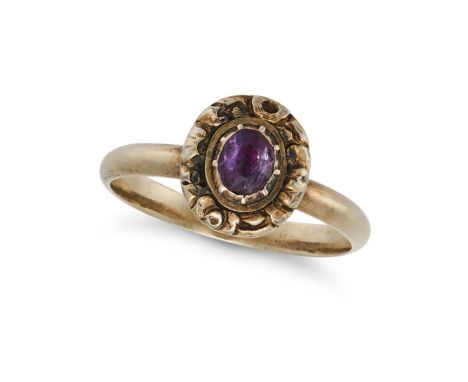 AN AMETHYST RING set with an oval cut amethyst in a foliate style border, no assay marks, size J1/2 / 5, 2.0g.&nbsp;