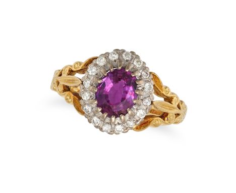 A RUBY AND DIAMOND CLUSTER RING in 18ct yellow gold, set with an oval cut ruby of approximately 1.05 carats in a cluster of r