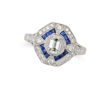 A SAPPHIRE AND DIAMOND DRESS RING in platinum, set with an emerald cut diamond of approximately 0.40 carats, accented by Fren