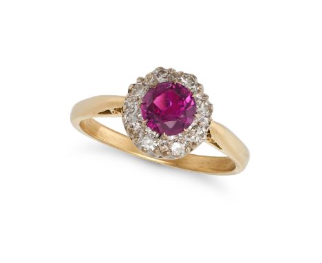 A RUBY AND DIAMOND CLUSTER RING in 18ct yellow gold and platinum, set with a round cut ruby of approximately 0.62 carats in a