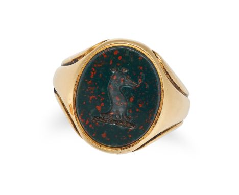 A BLOODSTONE SIGNET RING in 18ct yellow gold, set with an oval bloodstone intaglio carved to depict a dog's head, full Britis