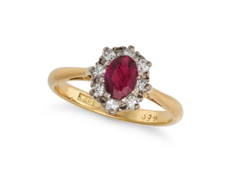 A VINTAGE RUBY AND DIAMOND CLUSTER RING in 18ct yellow gold, set with an oval cut ruby of approximately 0.70 carats in a clus